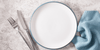 Empty plate with fork and knife to represent fasting