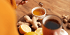 Ginger, honey, lemon, and tea on a tray which are Natural Immunostimulants