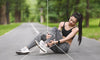 Woman sitting on the ground after running showing signs of inflammation