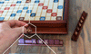 Person playing scrabble which is one of the best brain games to keep your mind sharp