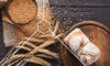 Bread and wheat on a table which are foods that can help digestion