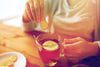 woman drinking a cup of tea with lemon to boost immunity