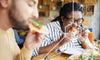 man and woman eating a meal together