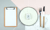 Clipboard, empty plate with a clock on it, and fork and knife representing fasting tips