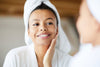 Woman looking in a mirror and checking for signs of autophagy