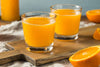two glasses of orange juice that are high in polyamines
