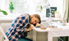 Woman asleep at her desk taking a break from work anxiety