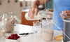 Man pouring milk into glass with supplements that help increase metabolism