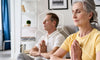 Older couple practicing meditation to promote healthy aging