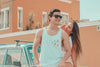 Young couple sitting on hood of car
