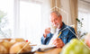 Man drinking tea and doing a crossword puzzle to improve his mind