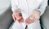 Doctor holding a model brain and top vitamins for brain health