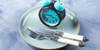 Clock on empty dinner plate with fork and knife representing intermittent fasting