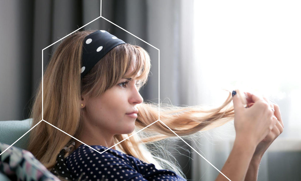 Woman looking at her brittle hair