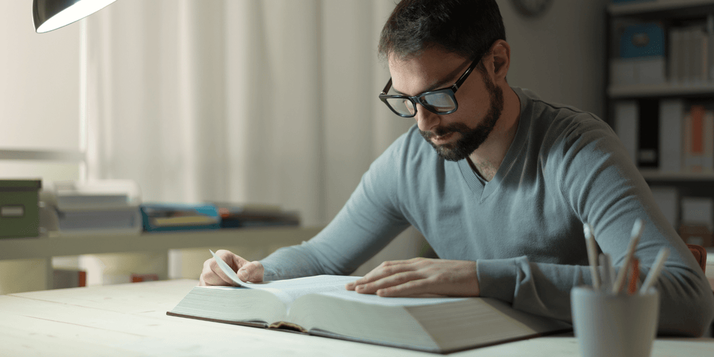 Man reading a book to improve brain health