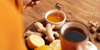 Ginger, honey, lemon, and tea on a tray which are Natural Immunostimulants 