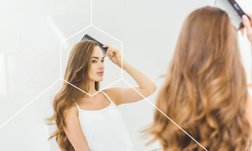 Woman coming her hair while looking in a mirror and thinking about what foods are bad for hair growth