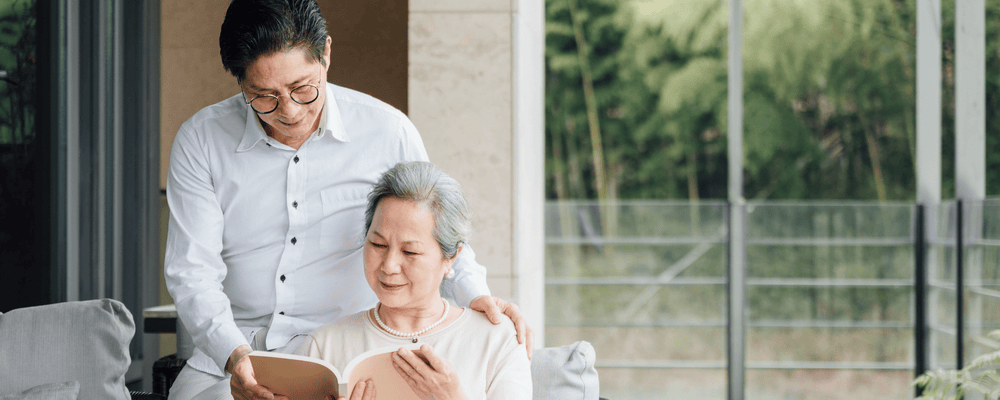 Elderly woman with a younger man experiencing how aging affects learning ability