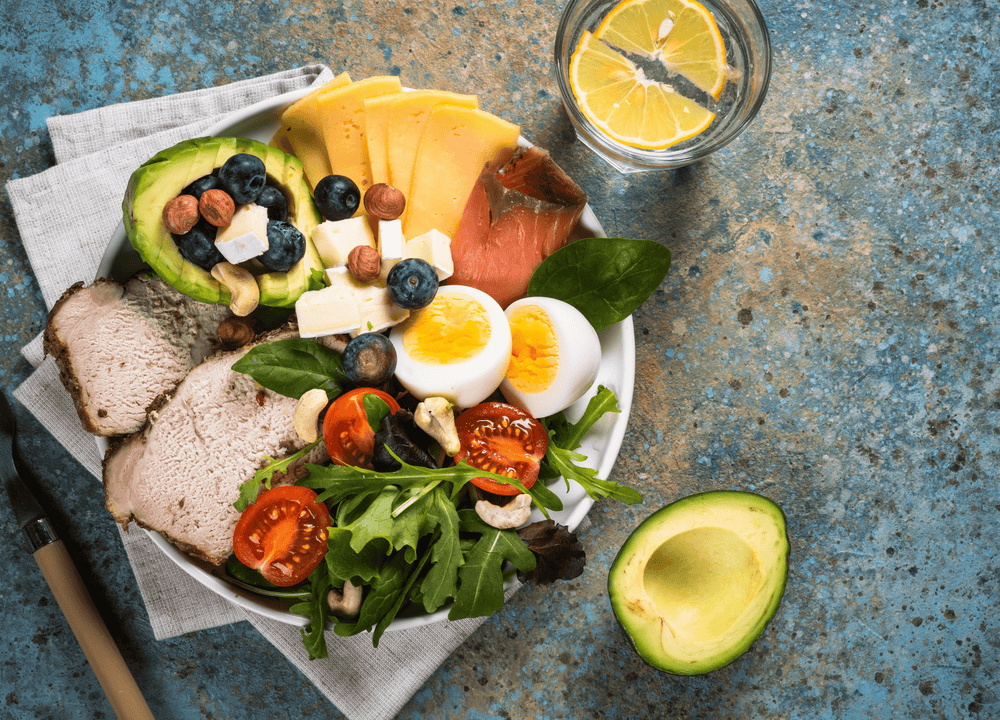 Healthy meats, vegetables, and cheeses on a plate consistent with the Alzheimer's prevention diet