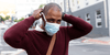 Man putting on a mask while heading to get a vaccination