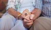 Elderly couple holding hands enjoying a long life 
