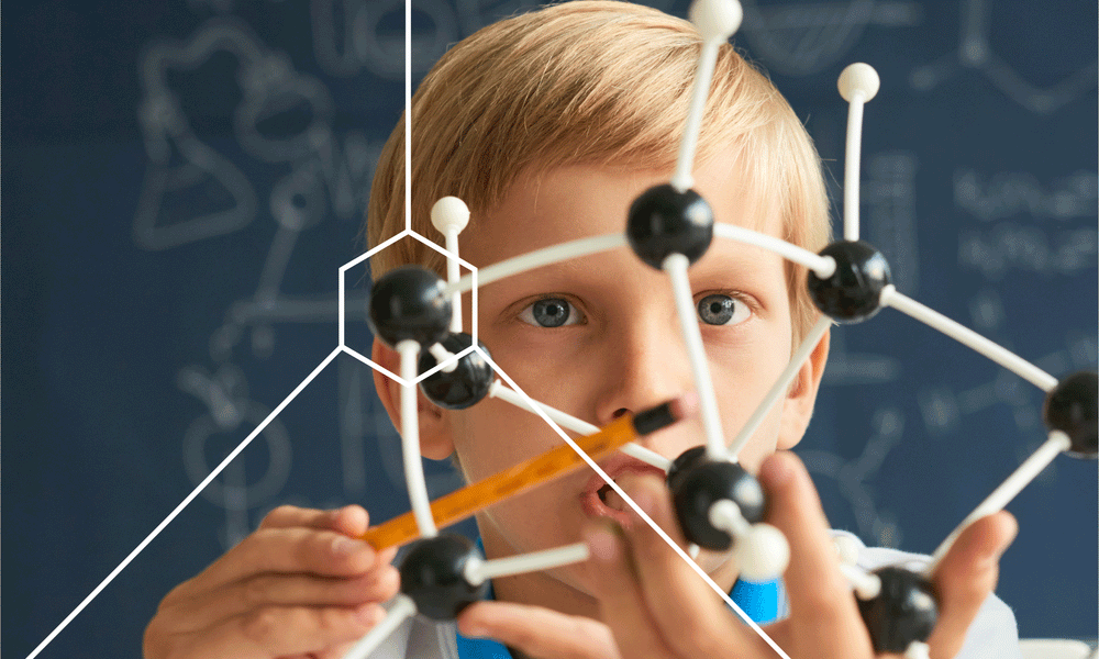 Child looking at a model of atoms and learning how the brain processes information