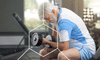 Older man working out at the gym working to stop muscle loss as he ages