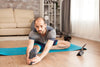 man doing stretches on a mat to reduce stress levels to boost immune health