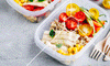 Bowls of chicken, rice, tomatoes, and corn used for meal planning for intermittent fasting