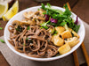 Noodles, mushrooms, and meat in a bowl that are part of a traditional Okinawan Diet