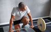 Elderly man working out with weight equipment and experiencing how aging affects muscular strength