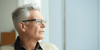 Elderly man looking off in the distance thinking of ways to prevent memory loss in old age