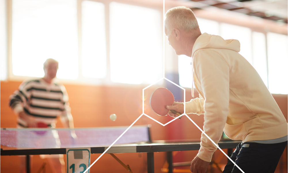 Two old men playing table tennis