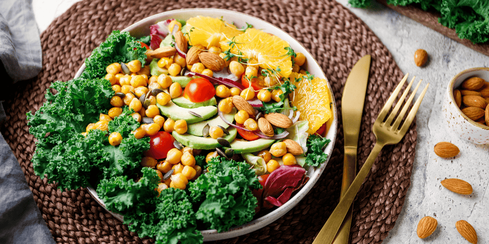 Bowl of beans, citrus, tomatoes, and other foods that contain spermidine