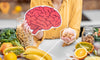 Woman holding nootropics laying on a table with fruits and vegetables with a graphic of a brain