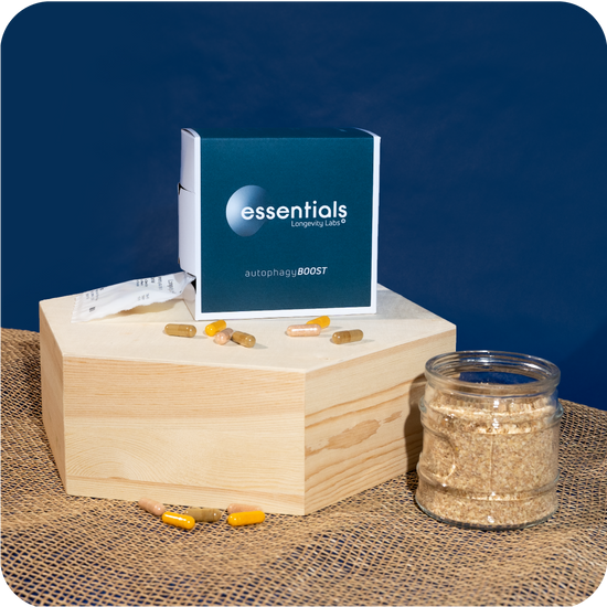 A wooden box with a bottle of essential oils, promoting cellular health and autophagy.