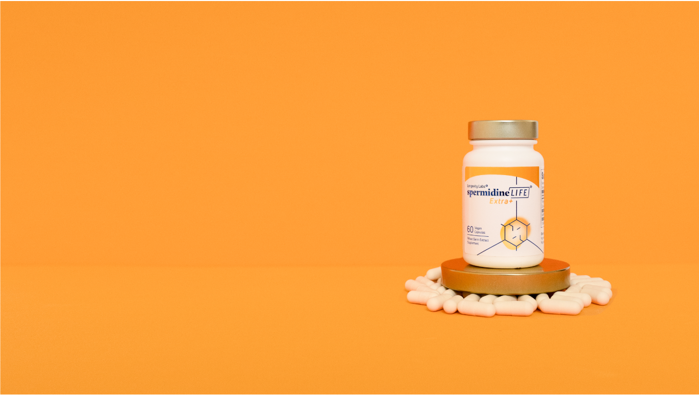 A bottle of vitamin C promoting cellular health on an orange background.